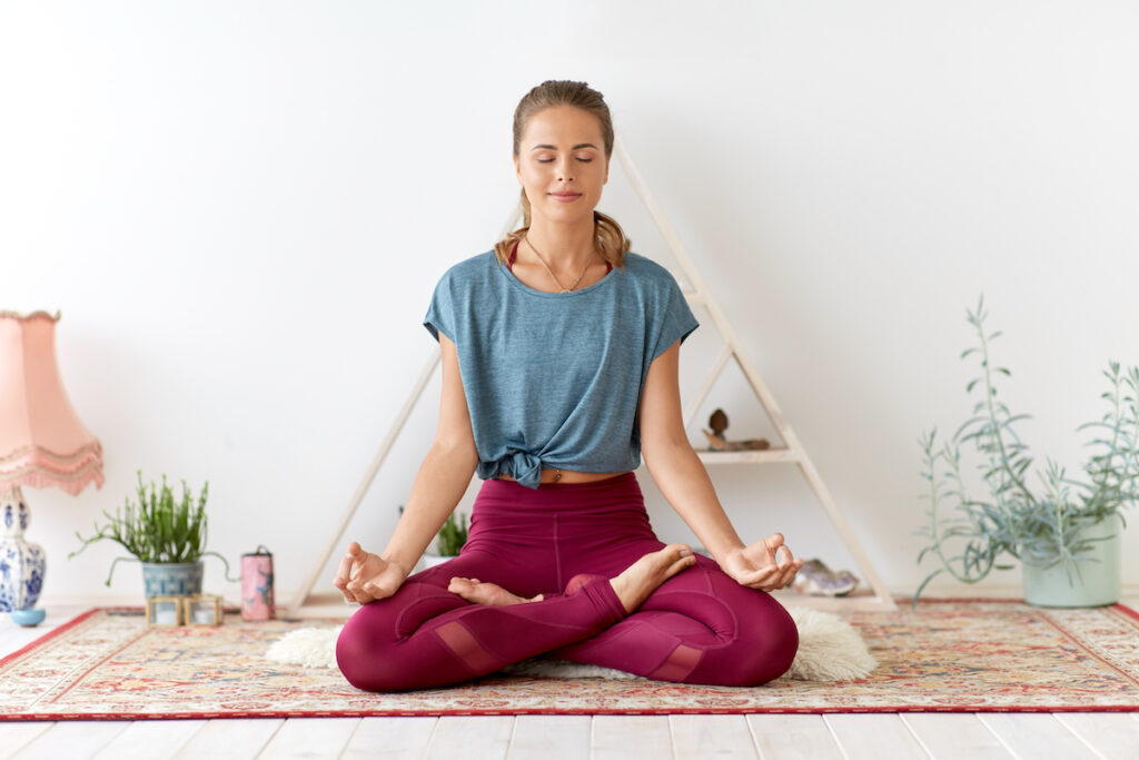 woman in seated meditation sitting in lotus position.