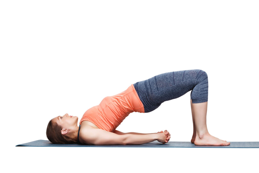 Female yogi practicing bridge pose.