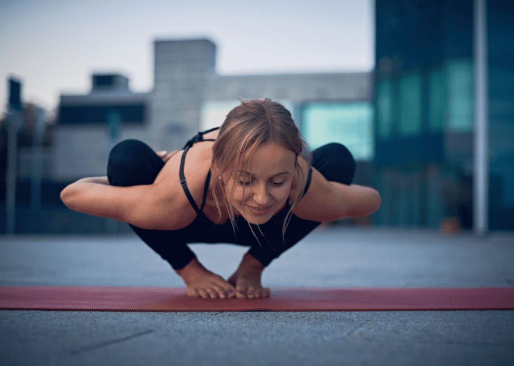 Woman performing full bind Malasana or Garland yoga pose.