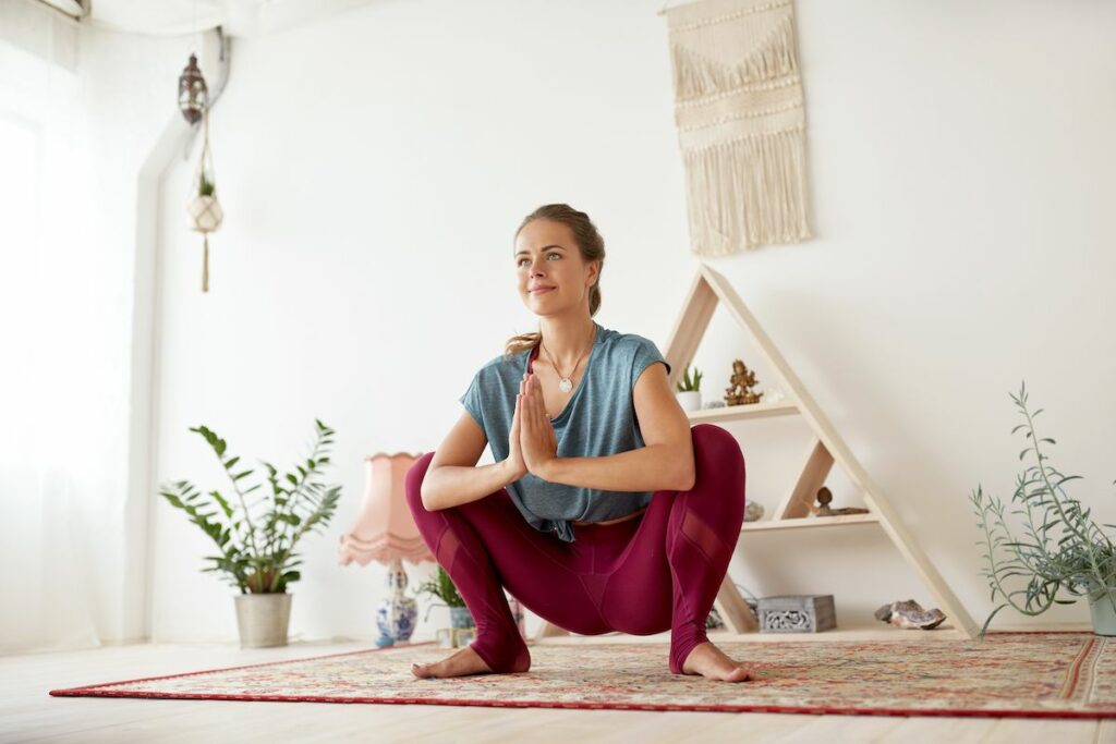 Female yogi in Malasana yoga pose.