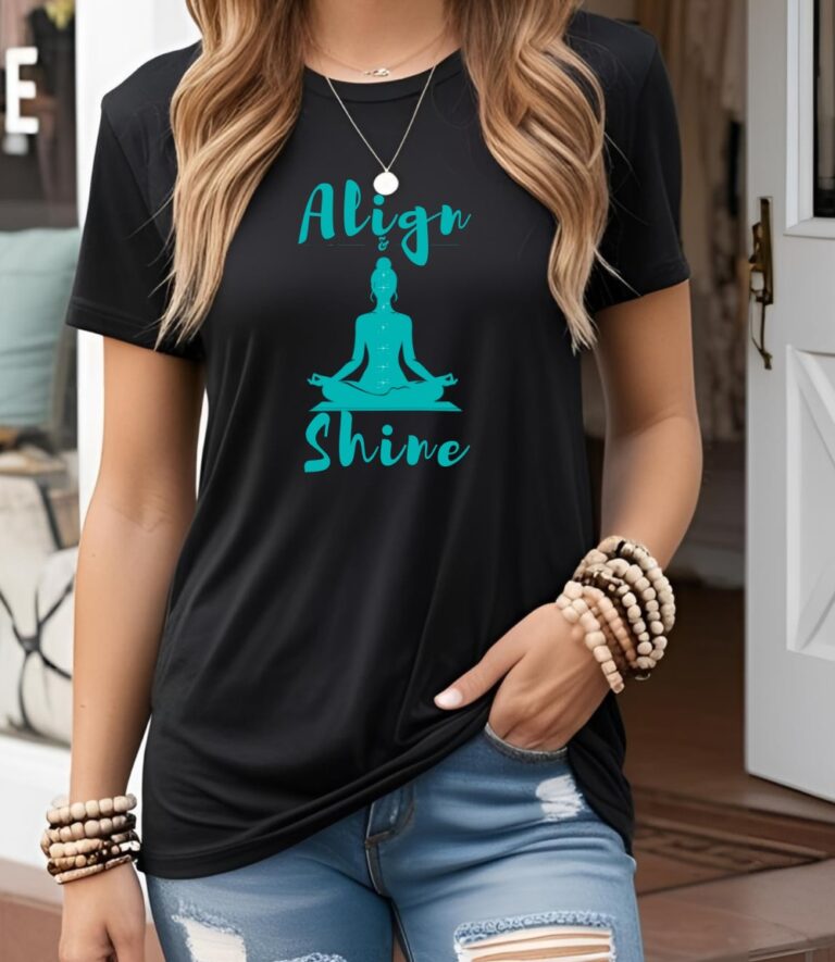 Female yogi with long hair wearing a casual black yoga graphic print t-shirt that says Align & Shine.