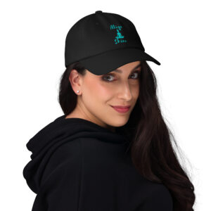Woman with long black hair wearing a black yoga trucker hat that says align and shine and has a graphic print of a female yogi sitting in lotus position.