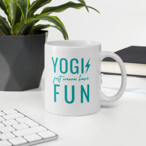 White ceramic coffee cup with a graphic print design that says yogis just wanna have fun printed on both sides of the cup.