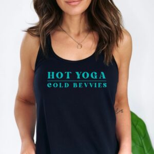 Female yogi with long brown hair wearing a black racerback yoga tank top with Hot Yoga Cold Bevvies graphic print.
