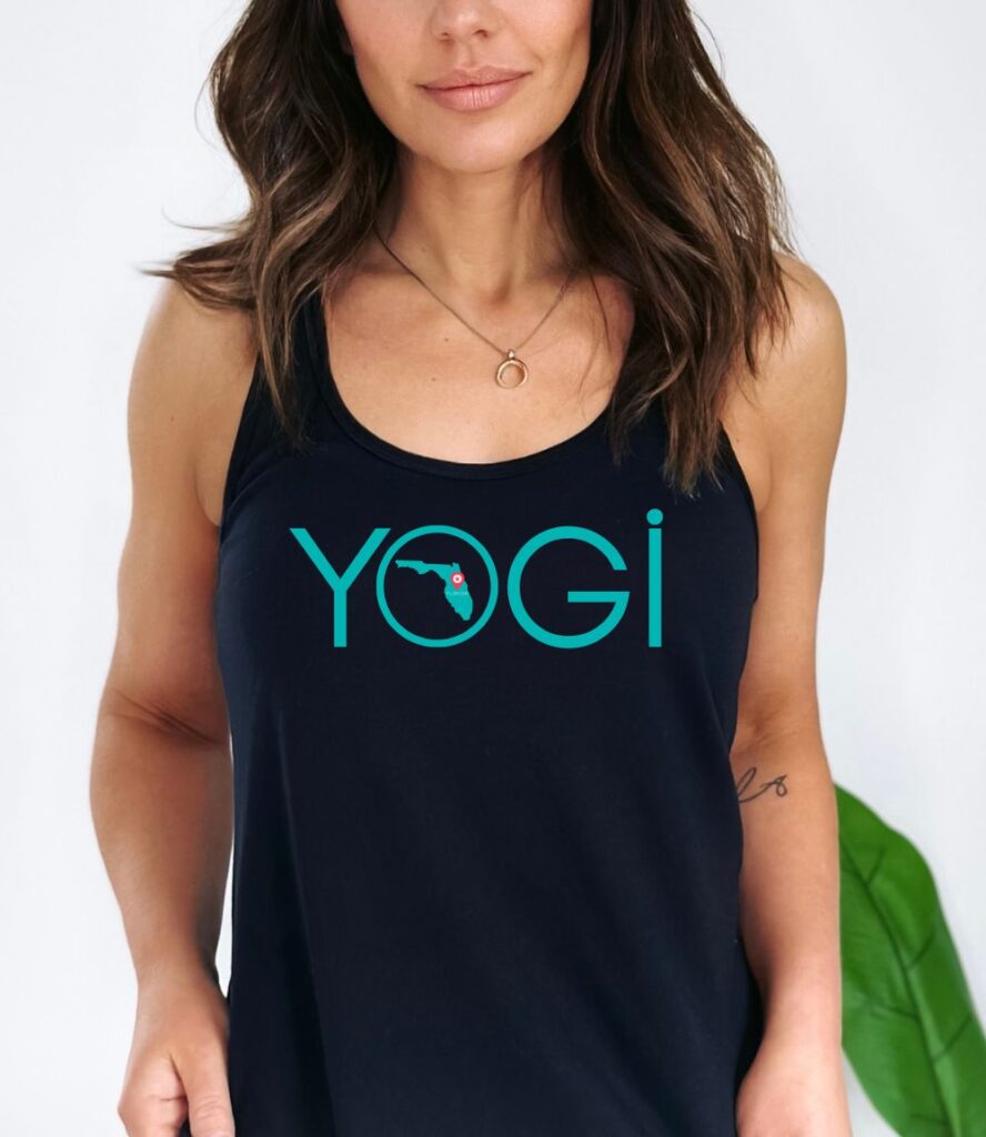 Female yogi with long brunette hair wearing a black racerback yoga tank top with a graphic of Florida State and the word yogi.