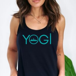 Female yogi with long brunette hair wearing a black racerback yoga tank top with a graphic of the NY city skyline and the word yogi.